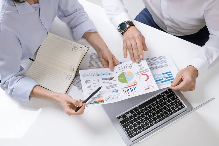 Consultants analyzing manufacturing workflow data